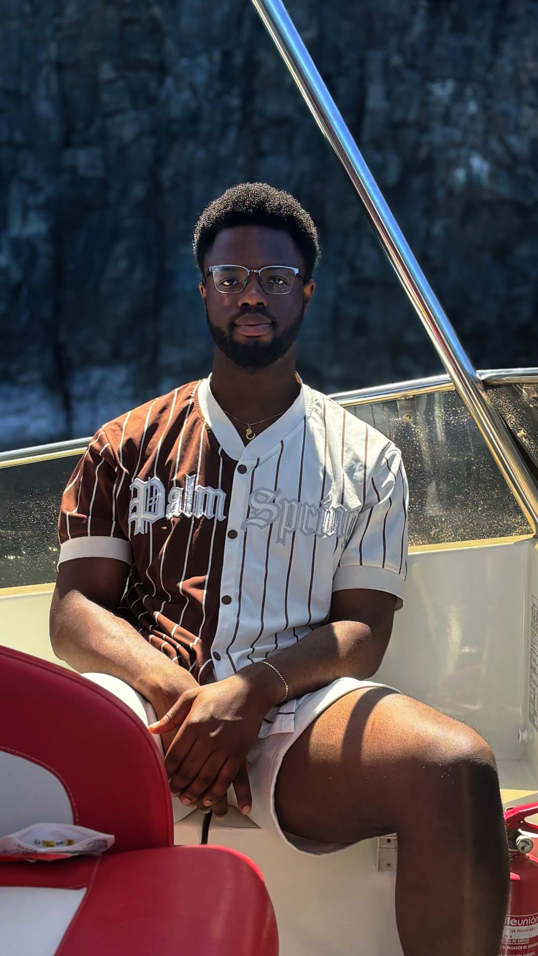 Anderson, founder of Selah Marketing, wearing glasses and seated on a boat